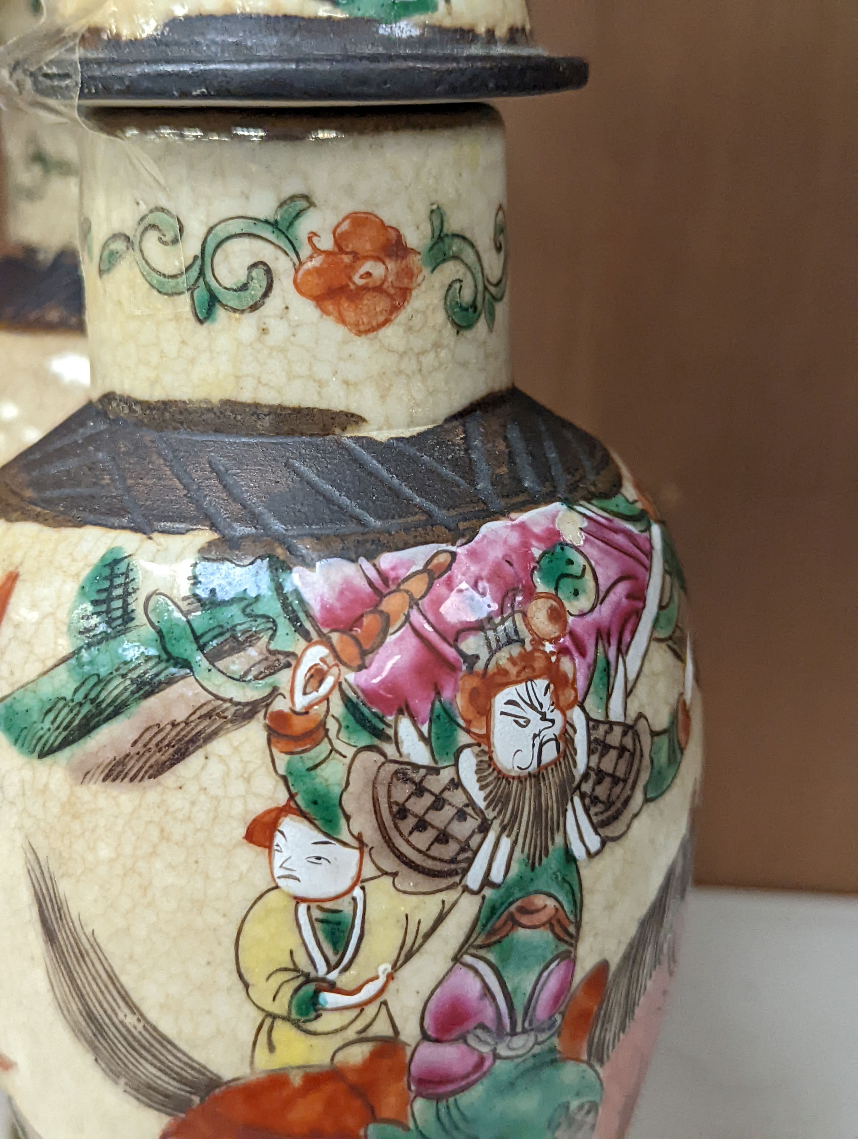 A pair of Chinese famille rose crackle glaze baluster jars and covers, 27cm.
